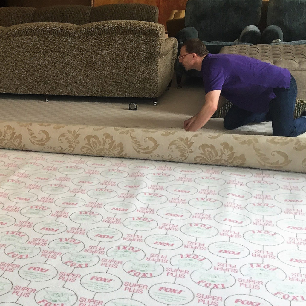 Classic Rug Care | Richard unrolling a bespoke rug